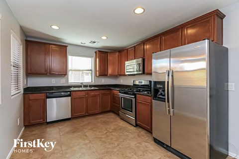 a kitchen with stainless steel appliances and wooden cabinets
