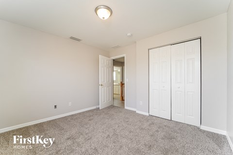 a bedroom with two closets and a door to a hallway