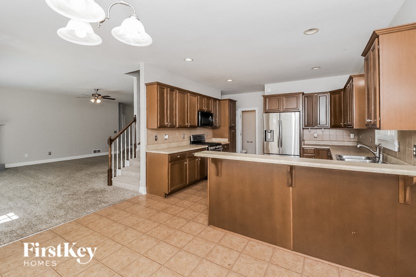 a kitchen with wooden cabinets and a white counter top