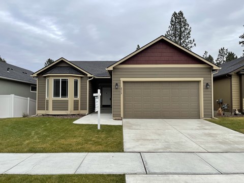 a home with a driveway and a garage door