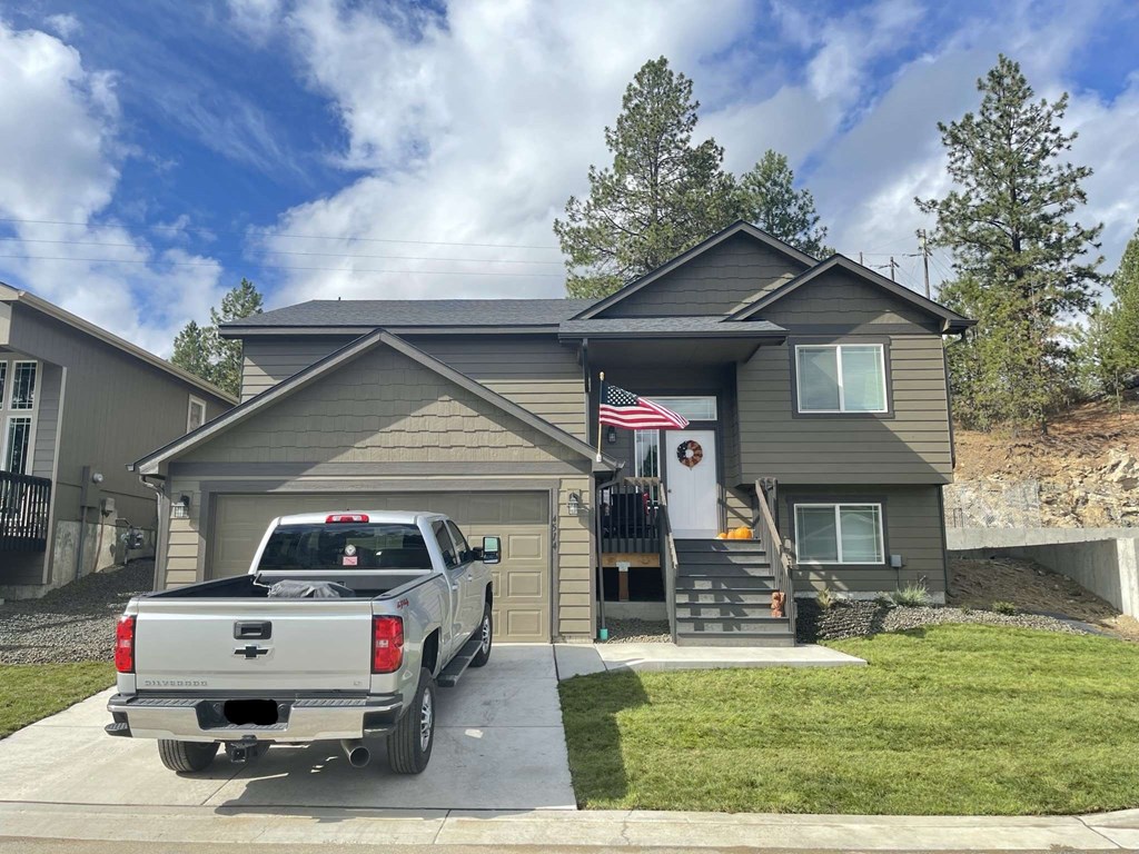 a truck parked in the driveway outside of a house