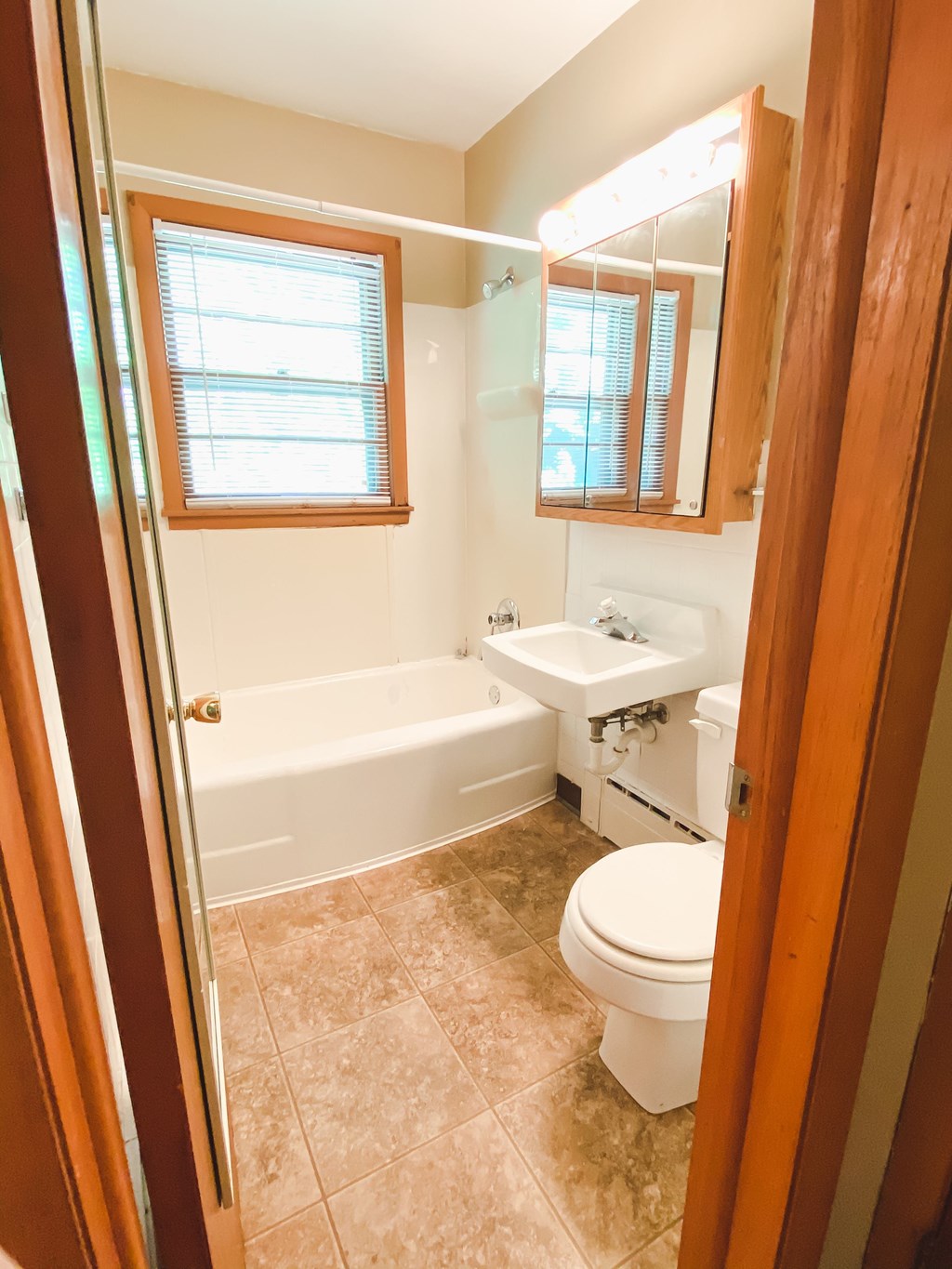 a small bathroom with a toilet and a sink and a bath tub