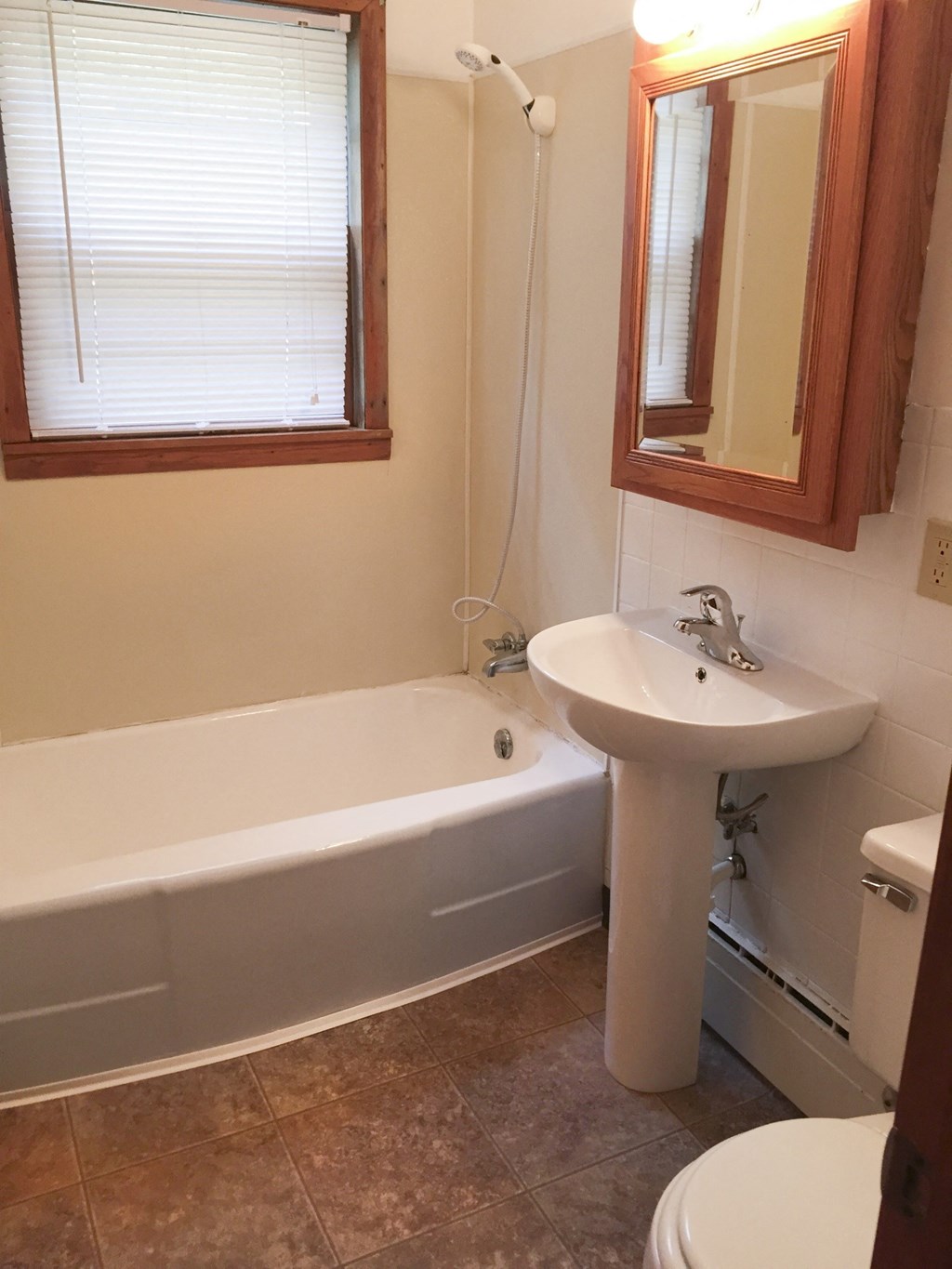 a small bathroom with a sink and a bath tub