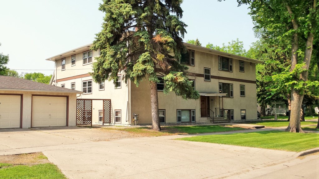 a large house with a tree in front of it
