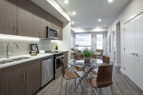 A modern kitchen with a dining table and chairs.