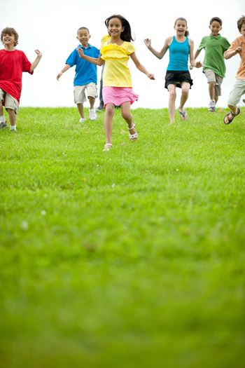 kids running on grass field