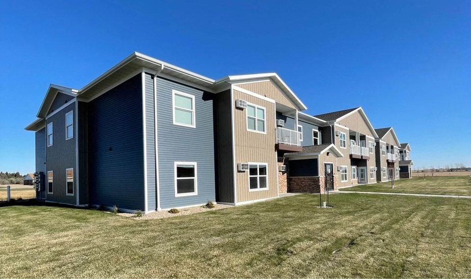 a row of houses on a grass field