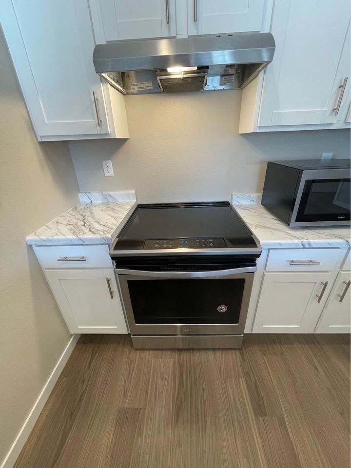 a kitchen with a stove and a microwave