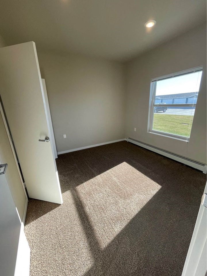 an empty room with a window and a door