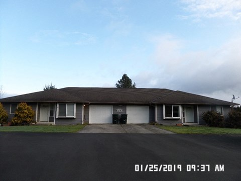 A house with a driveway in front of it.