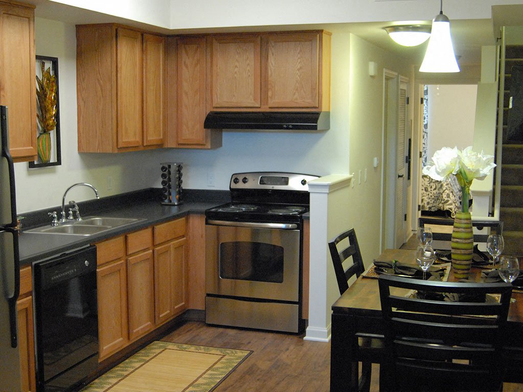 a kitchen with stainless steel appliances and wooden cabinets