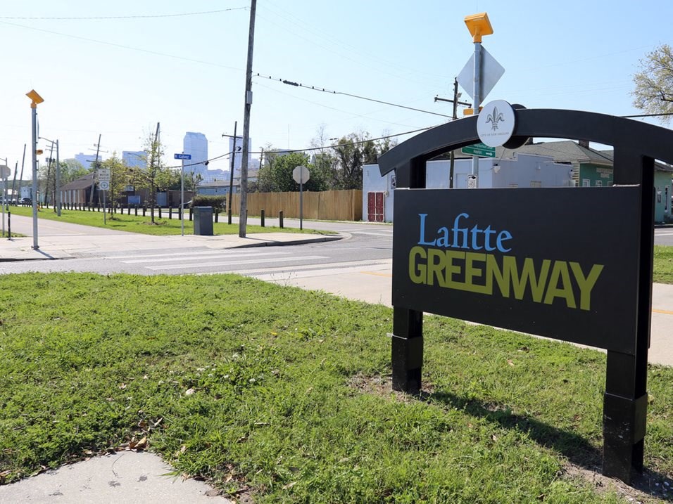 a sign for a little greenway on the side of a street
