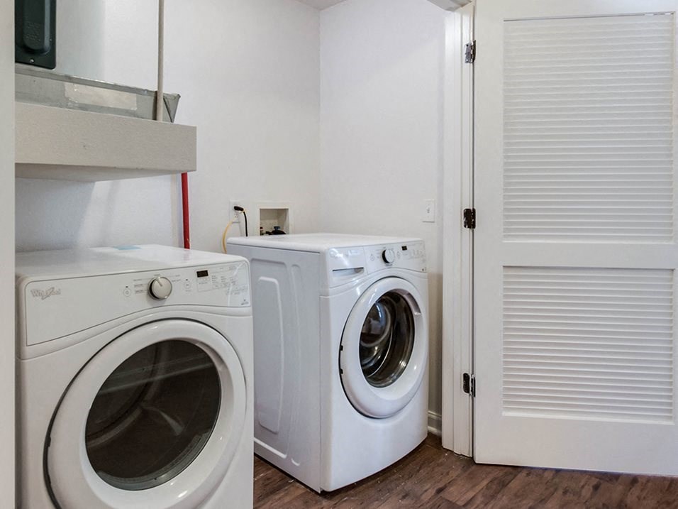 a washer and a dryer in a laundry room with a door