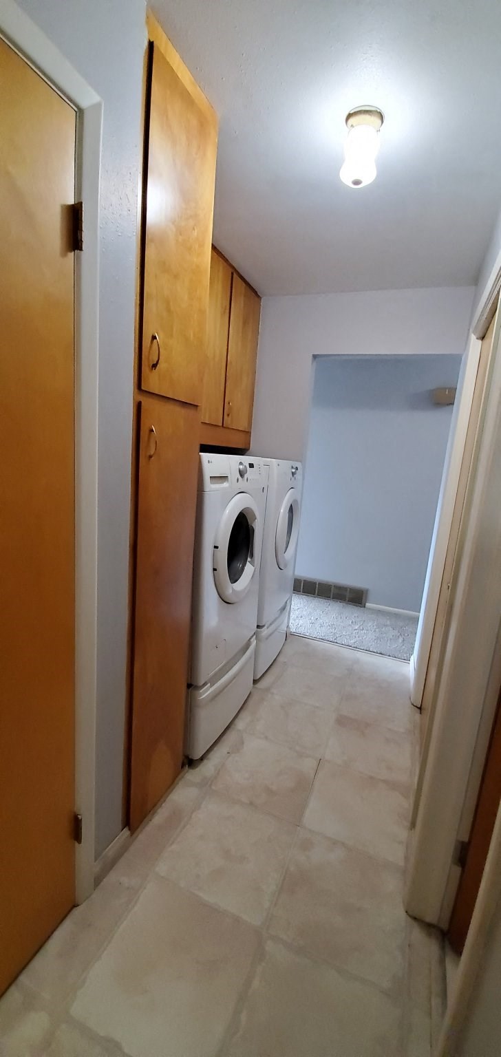 a laundry room with a washer and dryer in it
