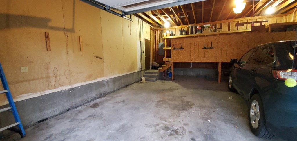 a car parked in a garage next to a wall