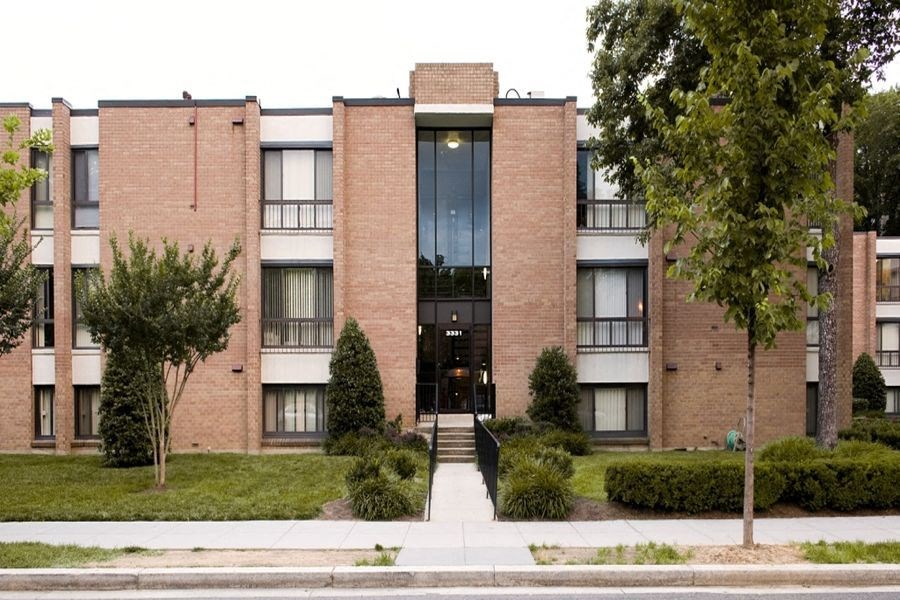 a brick building with a sidewalk in front of it