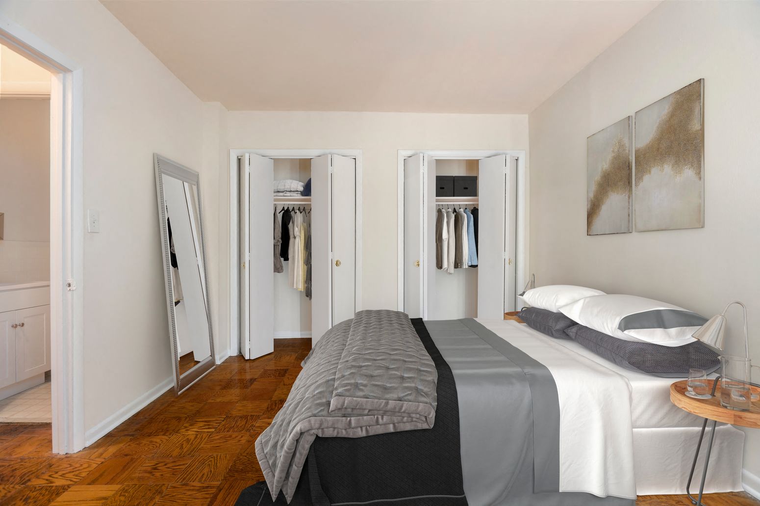 a bedroom with a bed and a closet      and three doors