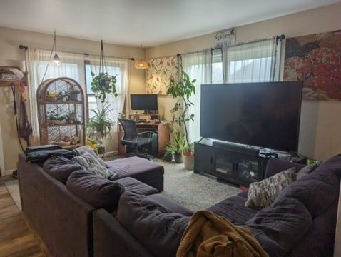 A living room with a large couch and a flat screen TV.