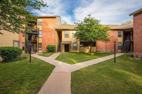 our apartments have a spacious courtyard with grass and trees