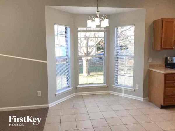 A room with a FirstKey Homes logo on the bottom left corner.