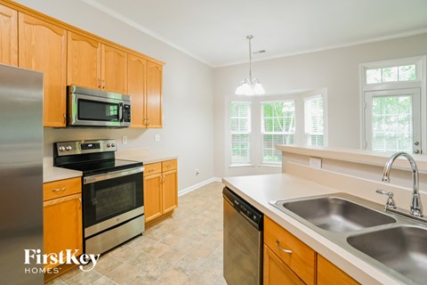 A kitchen with wooden cabinets and stainless steel appliances.
