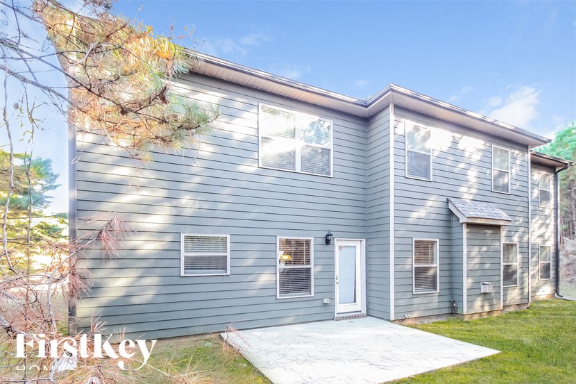 a blue house with a white sidewalk in front of it
