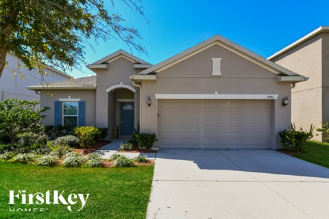 A house with a blue door and a garage is for sale.