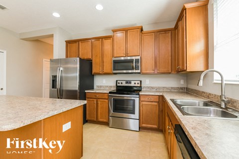 A kitchen with wooden cabinets and stainless steel appliances.