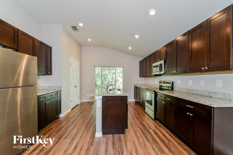 a kitchen with wooden cabinets and stainless steel appliances