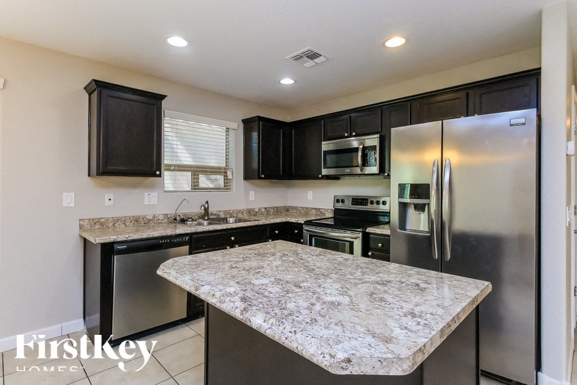 A kitchen with granite countertops and stainless steel appliances.