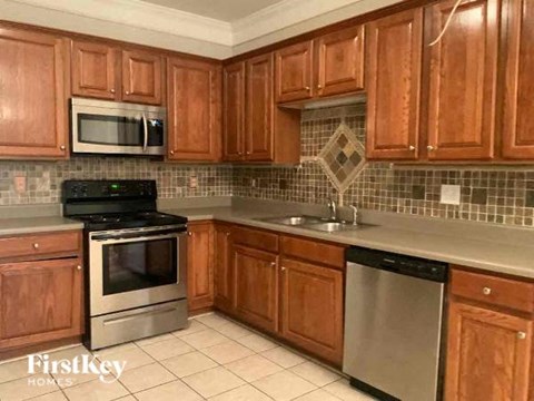 a kitchen with wooden cabinets and stainless steel appliances