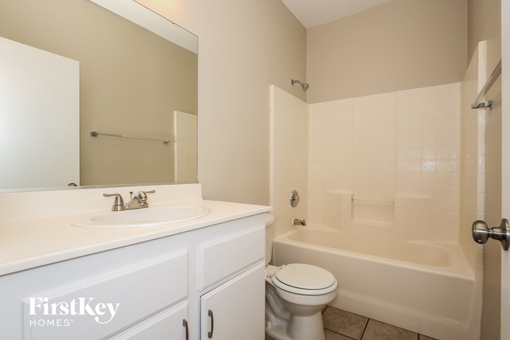 a bathroom with a sink toilet and a tub