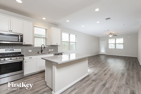 a kitchen with white cabinets and a white counter top