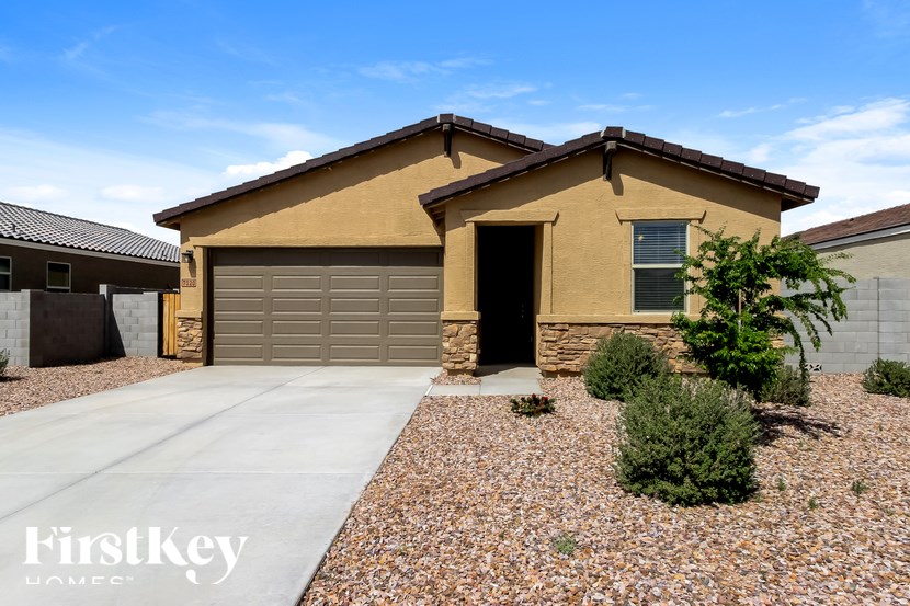 A house with a brown roof and a garage door.