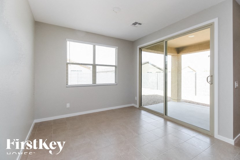 A room with a sliding glass door leading to a balcony.