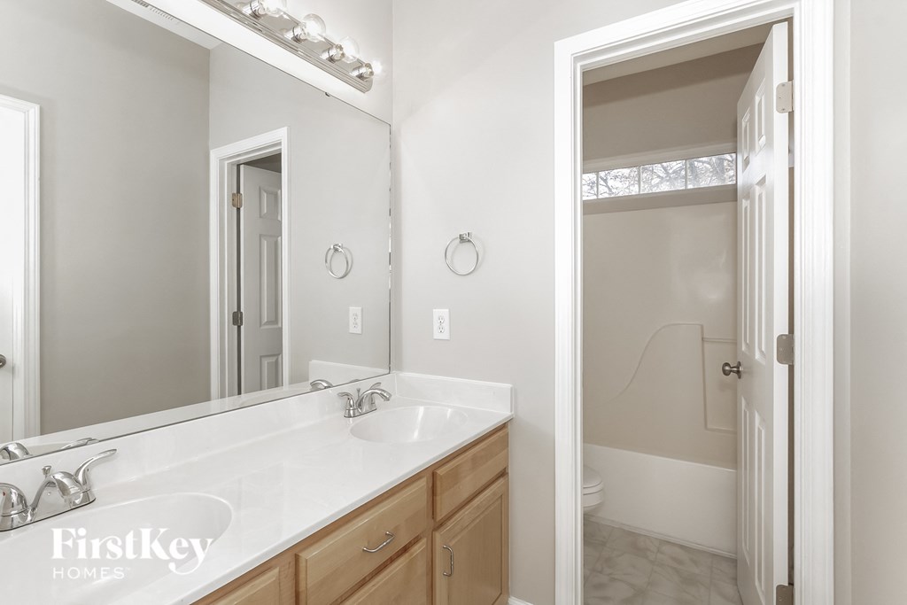 a bathroom with two sinks and a large mirror