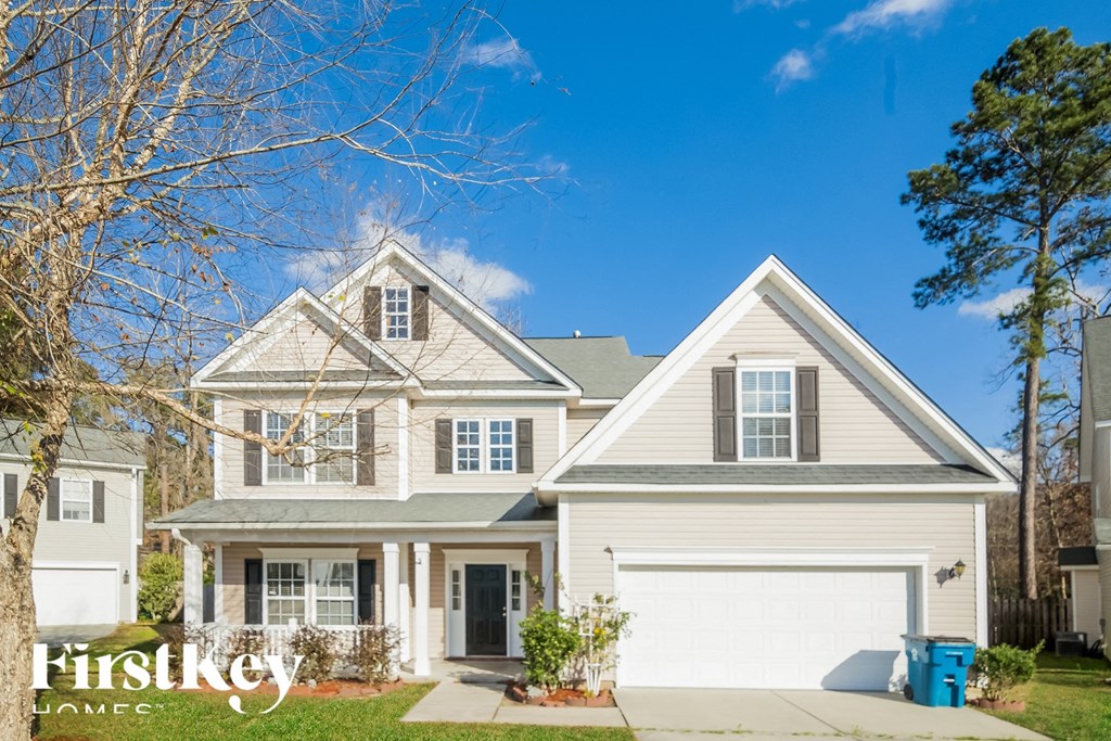 A two-story house with a garage is for sale.
