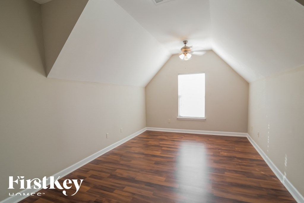 A room with wooden floors and a window.
