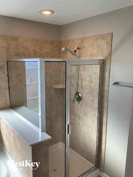 a bathroom with a shower with a glass door