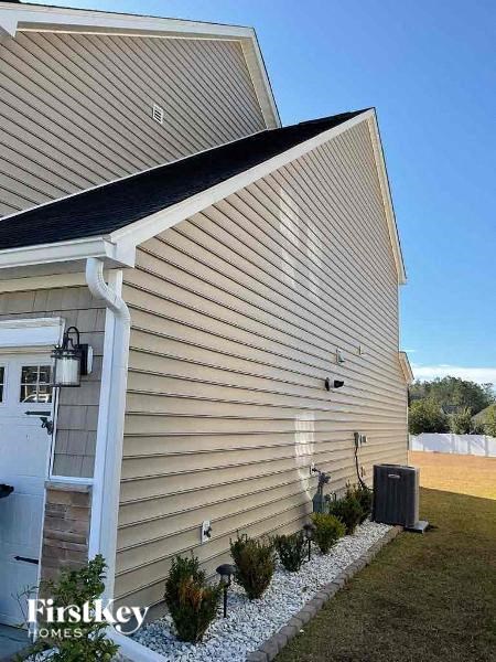 the side of a house with a garage and a porch