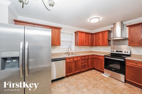 a kitchen with wooden cabinets and stainless steel appliances