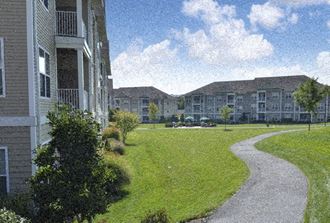an image of an apartment building with a walkway