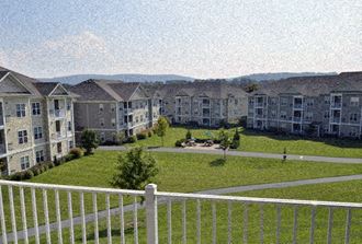 an aerial view of an apartment complex with a white fence