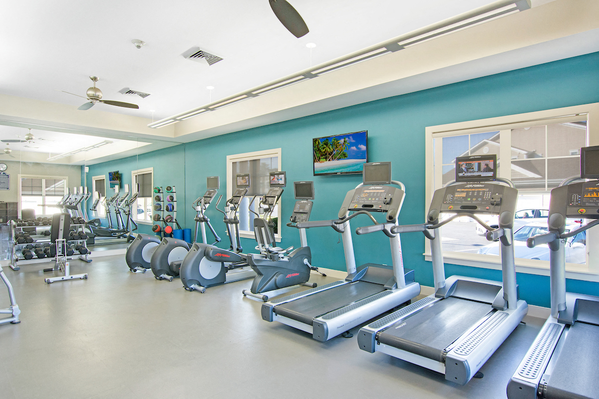 a gym with cardio equipment and treadmills