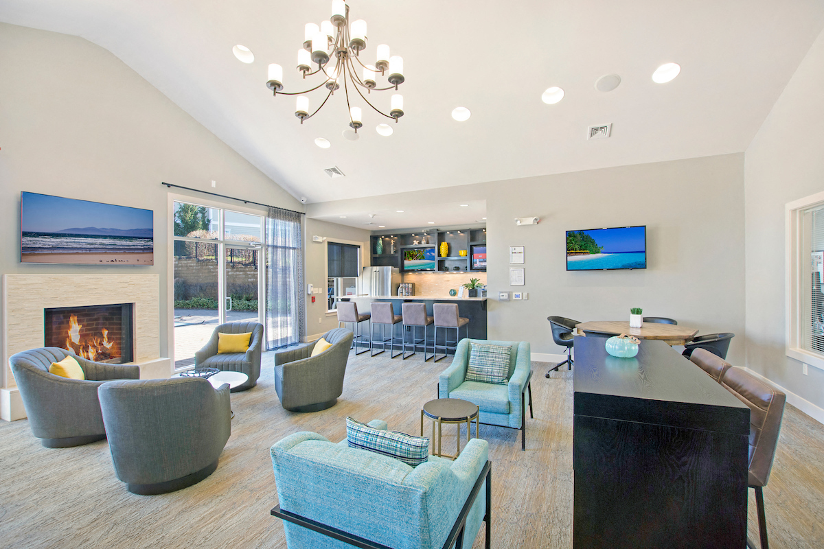 a living room with couches and chairs and a fireplace