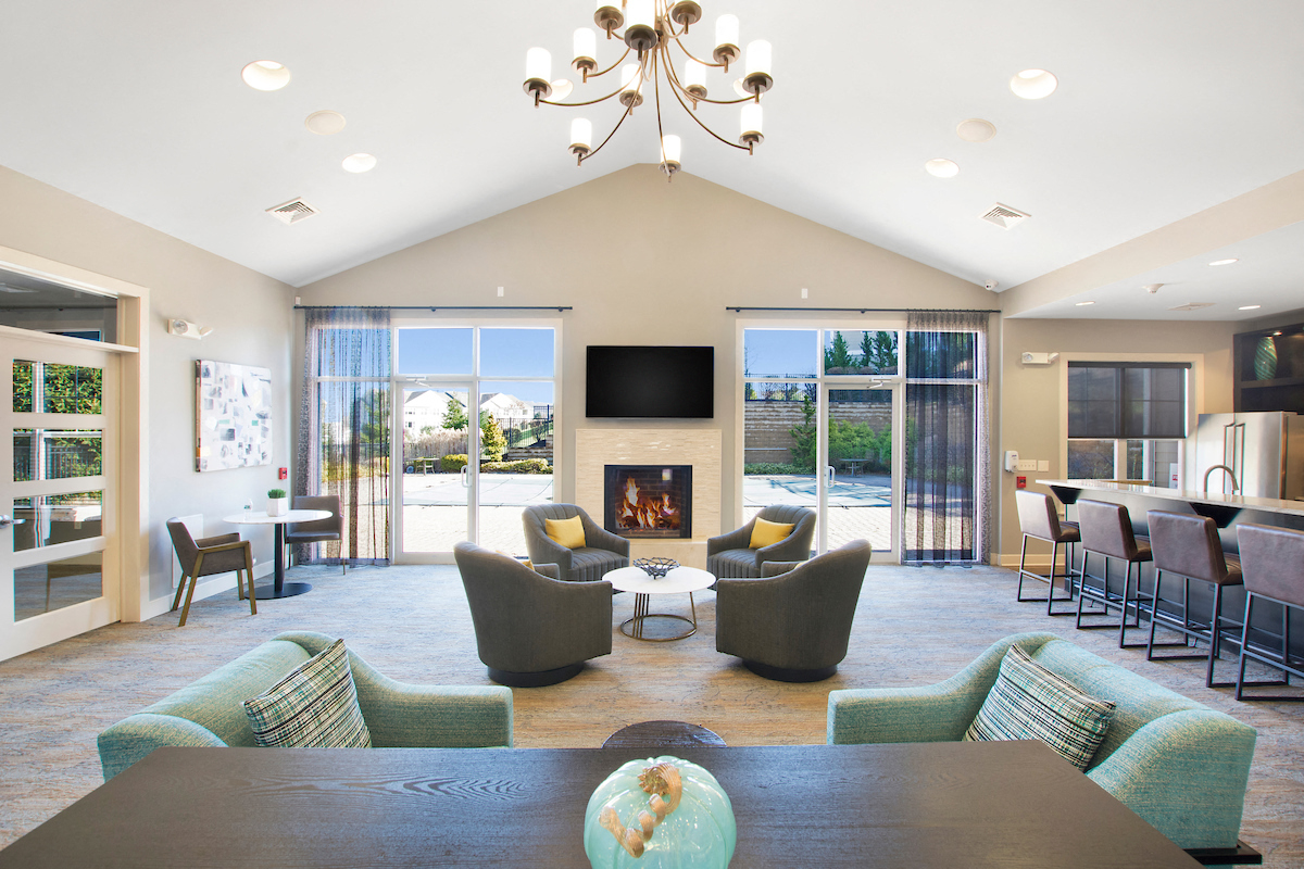 a living room with a table and chairs and a fireplace