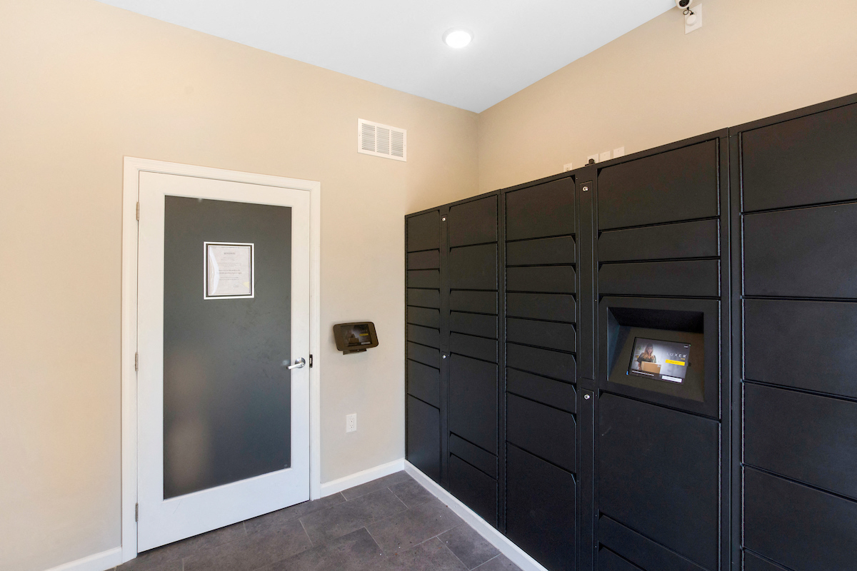 a laundry room with black cabinets and a door