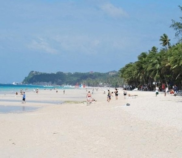 A beach scene with people enjoying the sun and sand.