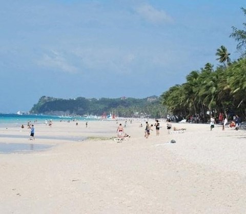A beach scene with people enjoying the sun and sand.