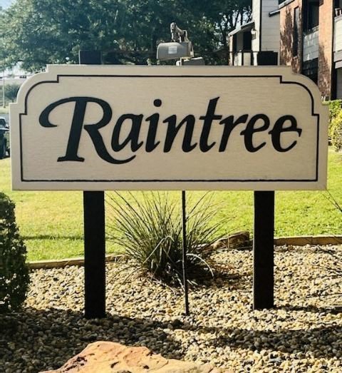 a sign that reads rainree in front of a house